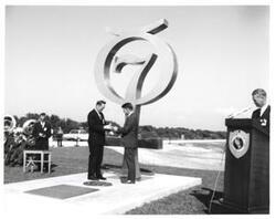 ["Black and white photograph of Astronaut Memorial Dedication Ceremonies. Astronaut Walter Schirra receives medallion from Roger Lewis. November 10, 1964"]