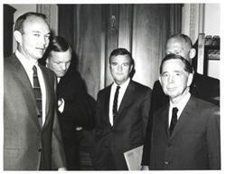 ["Black and white photograph of Carl Albert with astronauts."]