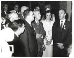 ["Black and white photograph of Carl Albert and group listening to an astronaut. Alan B. Shepard is pictured."]