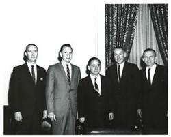 ["Black and white photograph of Carl Albert with a group of astronauts. Frank Borman and Edward White are pictured."]