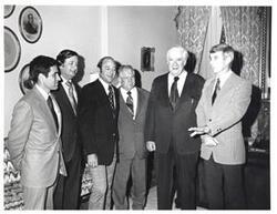 ["Black and white photograph of Thomas P. O'Neill with a group in Speaker's office."]