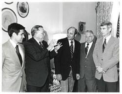 ["Black and white photograph of Thomas P. O'Neill with a group in Speaker's office."]
