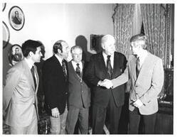 ["Black and white photograph of Thomas P. O'Neill with a group in Speaker's office."]