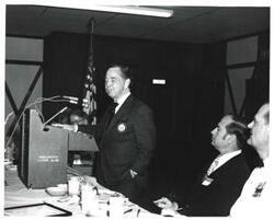 ["Black and white photograph of Carl Albert speaking at a banquet on Armed Forces Day. 1973 McAlester, Oklahoma."]