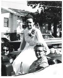 ["Black and white photograph of a group of people riding in a parade on Armed Forces Day in McAlester, Oklahoma. 1973"]