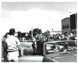 ["Black and white photograph of a group of people riding in a parade on Armed Forces Day in McAlester, Oklahoma. 1973"]