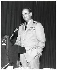 ["Black and white photograph of a military officer speaking at a banquet in McAlester, Oklahoma on Armed Forces Day 1973"]