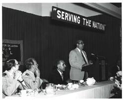 ["Black and white photograph of a banquet in McAlester, Oklahoma on Armed Forces Day 1973"]