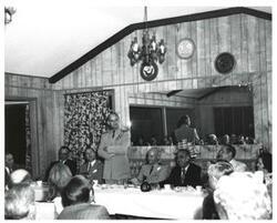["Black and white photograph of the speakers' a banquet in McAlester, Oklahoma on Armed Forces Day 1973"]