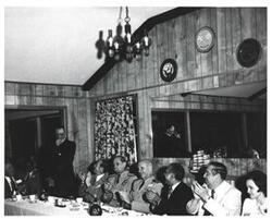 ["Black and white photograph of the speakers' a banquet in McAlester, Oklahoma on Armed Forces Day 1973"]