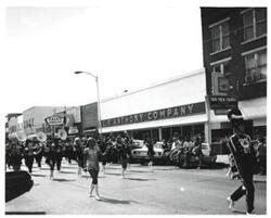 ["Black and white photograph of a parade in McAlester, Oklahoma on Armed Forces Day 1973"]