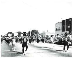 ["Black and white photograph of a parade in McAlester, Oklahoma on Armed Forces Day 1973"]