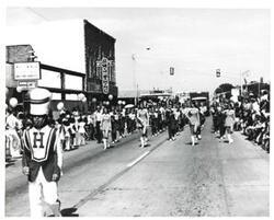 ["Black and white photograph of a parade in McAlester, Oklahoma on Armed Forces Day 1973"]