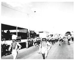 ["Black and white photograph of a parade in McAlester, Oklahoma on Armed Forces Day 1973"]