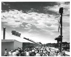 ["Black and white photograph of a train station in McAlester, Oklahoma on Armed Forces Day. 1973"]