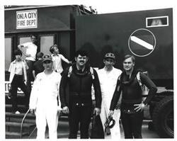 ["Black and white photograph of skin divers in McAlester, Oklahoma on Armed Forces Day. 1973"]