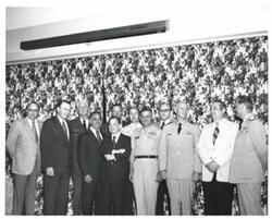 ["Black and white photograph of Carl Albert and Henry Bellmon with a group in McAlester, Oklahoma on Armed Forces Day. 1973"]