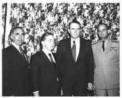 ["Black and white photograph of Carl Albert and Henry Bellmon in McAlester, Oklahoma on Armed Forces Day. 1973.  Two other unidentified men and one unidentified woman in photo."]