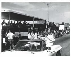 ["Black and white photograph of a parade in McAlester, Oklahoma on Armed Forces Day. 1974"]