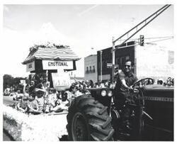 ["Black and white photograph of a parade in McAlester, Oklahoma on Armed Forces Day. 1978"]