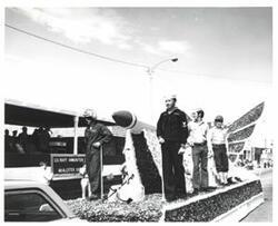 ["Black and white photograph of a parade in McAlester, Oklahoma on Armed Forces Day. 1978"]