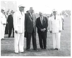 ["Black and white photograph of retreat review honoring Army veterans in Congress. June 12, 1960. Shot of four unidentified men at the event with Washington Monument in the background  (top right)"]
