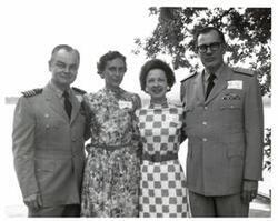 ["Black and white photograph of two military officers and two women in McAlester, Oklahoma on Armed Forces Day 1974"]