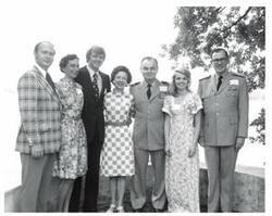 ["Black and white photograph of a small group of people in McAlester, Oklahoma on Armed Forces Day. 1974"]