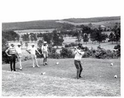 ["Black and white photograph of a golf game in McAlester, Oklahoma on Armed Forces Day. 1974"]