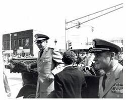 ["Black and white photograph of parade scenes in McAlester, Oklahoma on Armed Forces Day. 1974"]