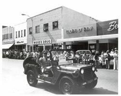 ["Black and white photograph of parade scenes in McAlester, Oklahoma on Armed Forces Day. 1974"]