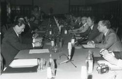 ["Black and white photograph print of Carl Albert sitting at a table with several men. This is during the House delegation trip to the USSR, Romania, and Yugoslavia. August 1975"]