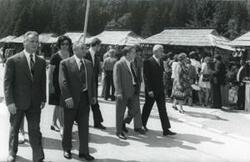["Black and white photograph print of Carl Albert walking down a street with several others during the House delegation trip to USSR, Romania, Yugoslavia. August 1975"]