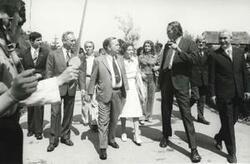 ["Black and white photograph print of Carl Albert and Mary Albert walking down a street with several others during the House delegation trip to the USSR, Romania, and Yugoslavia. August 1975"]