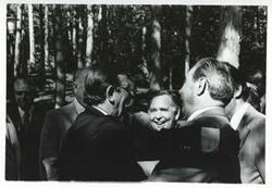 ["Black and white photograph print of Carl Albert and Leonid Brezhnev standing outside with several others. Yalta in August 1975"]