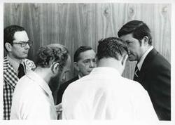 ["Black and white photograph print of Carl Albert talking with several men. August 1975"]