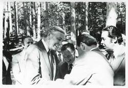 ["Black and white photograph print of Carl Albert and Leonid Brezhnev standing outside with several others. In Yalta, during the House delegation trip to USSR, Romania, Yugoslavia. August 1975"]