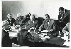 ["Black and white photograph print of Carl Albert seated at a table with Leonid Brezhnev and others. In Yalta for House delegation trip. August 1975"]