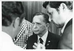 ["Black and white photograph print of Carl Albert talking with an unidentified man."]