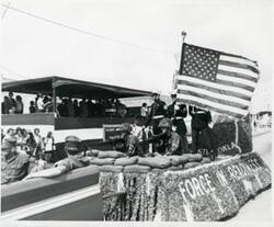["Black and white photograph of parade scenes in McAlester, Oklahoma on Armed Forces Day. 1974"]