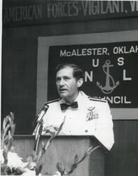 ["Black and white photograph of a military officer speaking at a banquet in McAlester, Oklahoma on Armed Forces Day. 1974"]