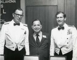 ["Black and white photograph of Carl Albert and two military officers in McAlester, Oklahoma on Armed Forces Day. 1974"]