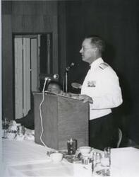["Black and white photograph of military officer speaking at a banquet in McAlester, Oklahoma on Armed Forces Day. 1969"]