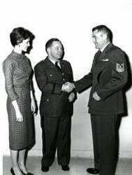 ["Black and white photograph of Carl Albert in Army reserve uniform shaking hands with another military member."]
