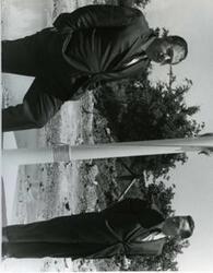 ["Carl Albert and an unidentified man standing next to a flagpole in McAlester, Oklahoma on Armed Forces Day. 1968"]