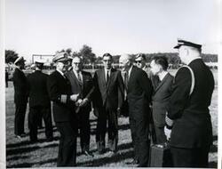 ["Carl Albert, guest, and naval officers. 1968"]