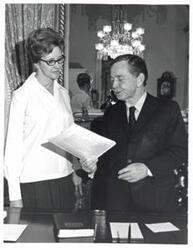 ["Black and white photograph of Carl Albert with Mrs. Donald (Maxine) Yost in the Speaker's office."]