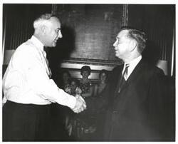 ["Black and white photograph of Carl Albert and unidentified people."]