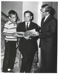 ["Black and white photograph of Carl Albert and unidentified people.  Based on Note on back of photo (not pictured) the adult man may be Reverend Bill Pedsham (?) and the child is Mark Harris (?)"]