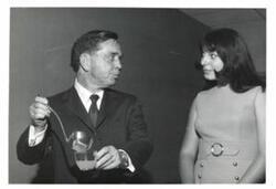 ["Black and white photograph of Carl Albert with a woman."]